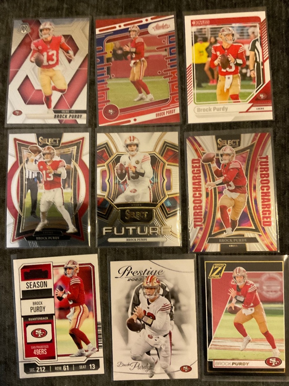 Brock Purdy. 9 Card Lot: Select, Mosaic, Absolute, Donruss, Zenith, Contenders